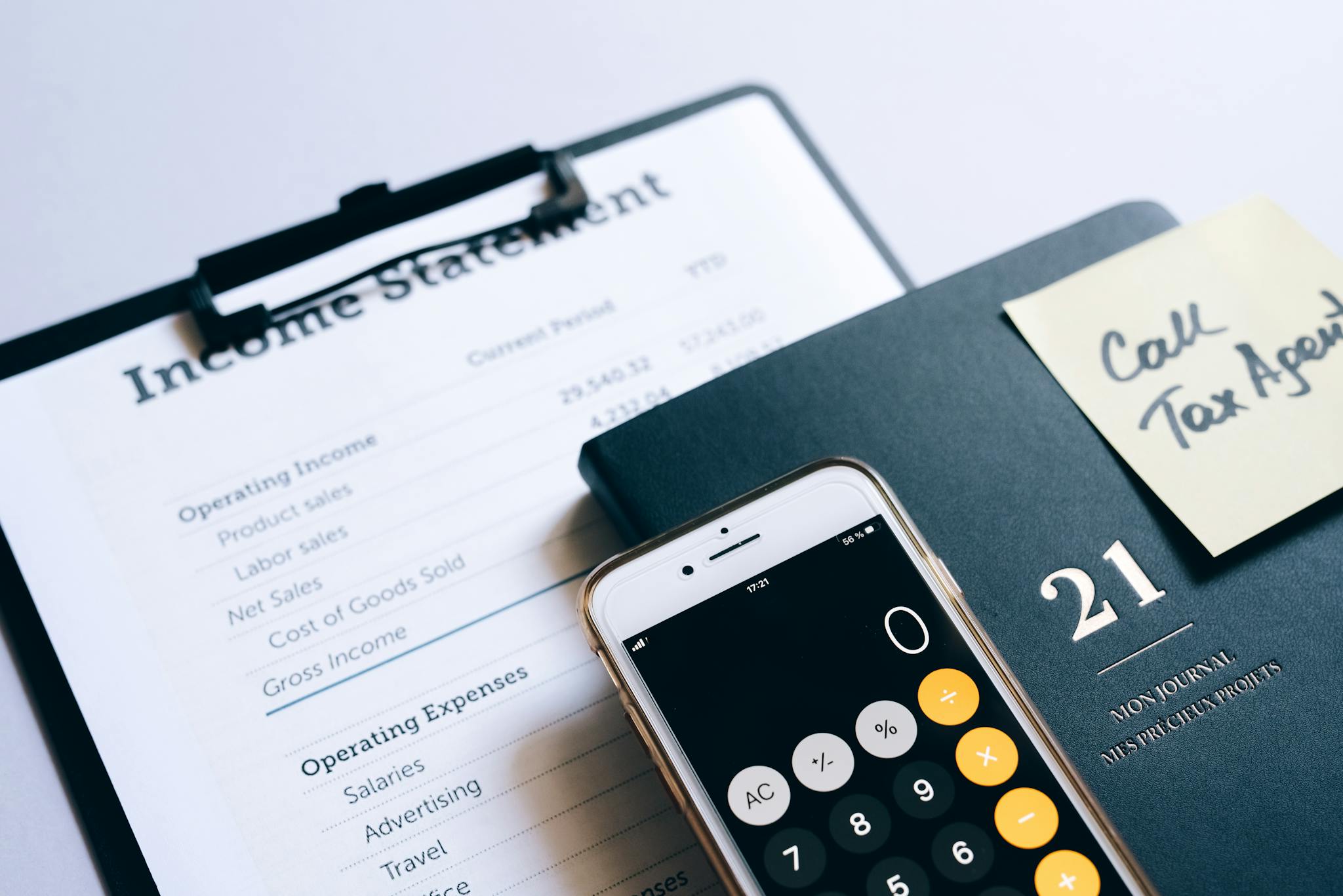 Close-up of income statement, calculator, and planner for financial planning.
